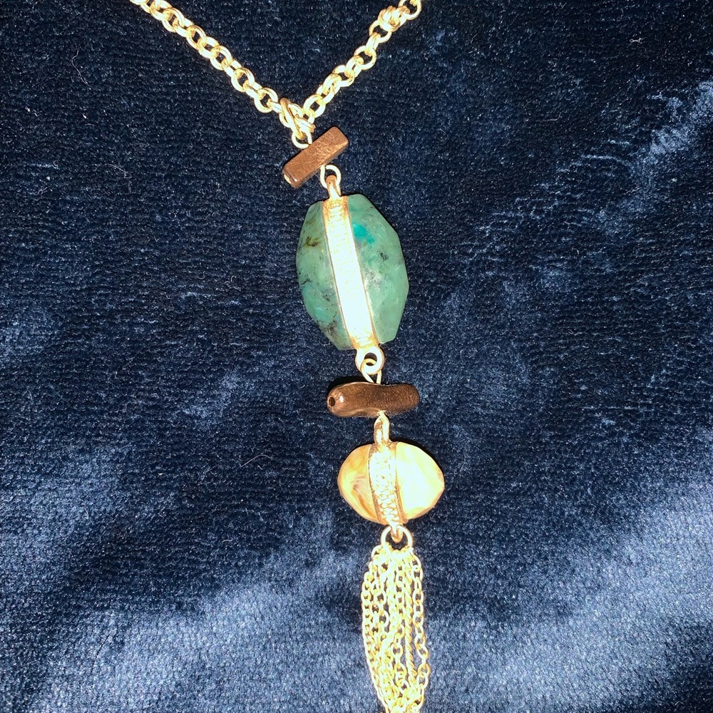 Long gold chain with green & yellow stone & tassel